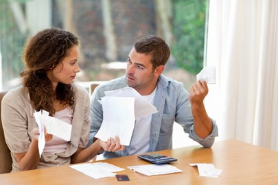 Young couple calculating their domestic bills at home-2-1